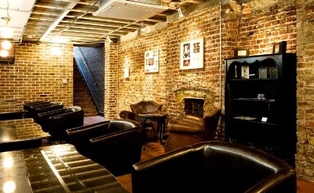 Leather chairs and exposed brick inside Hayato London